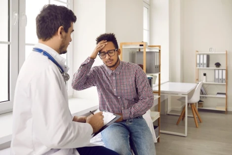 Man goes to doctor to get treated for a headache from a car accident.