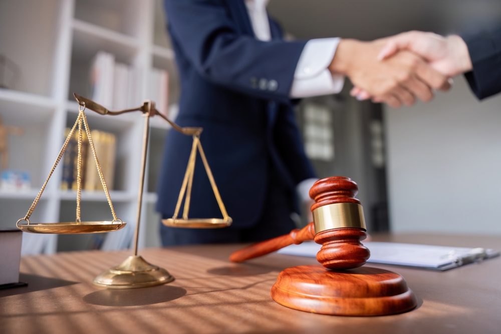 Lawyer meets with client to discuss why insurance companies want to settle out of court.
