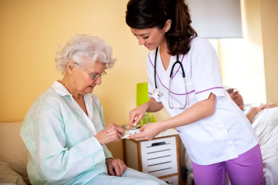 nurse helping an elderly patient