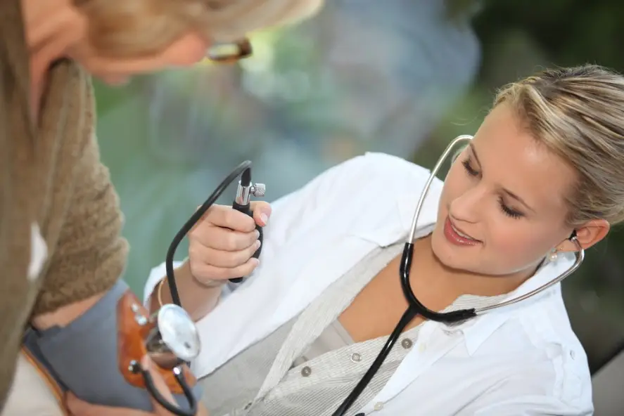 nurse taking patient’s blood pressure