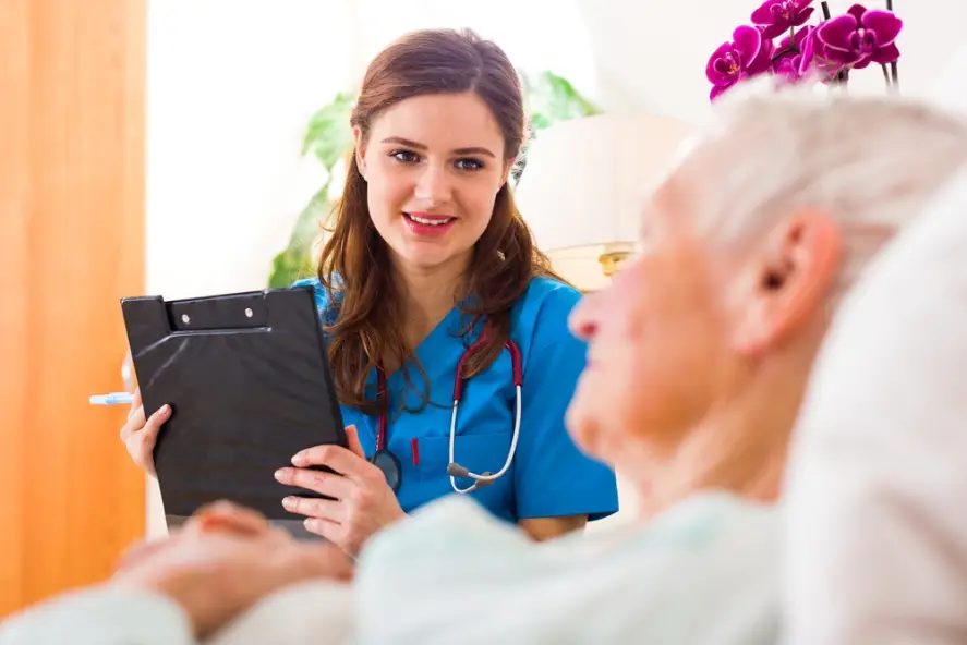 registered nurse talking to an elderly patient