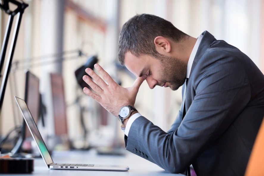 A frustrated-looking man facing complaints that may affect his tax professional license.