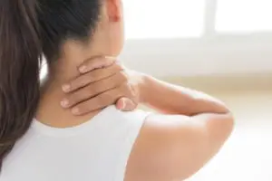 Asian woman massaging her neck