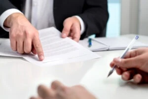 Signing,A,Contract,Or,Agreement.,Banker,Or,Lawyer,Showing,Client