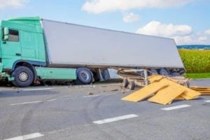 a truck on the side of the road with product in the road