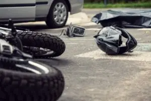 close-up of a motorcycle helmet and accident on the road