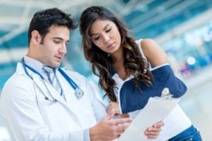 woman with a broken arm going over x-ray with her doctor