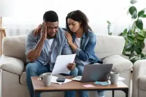 unhappy couple going over their finances