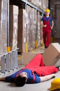 warehouse worker lying on the floor after a workplace-accident