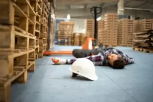 warehouse worker lying on the floor after an accident
