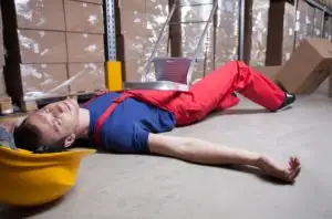 warehouse worker lying unconscious on the floor