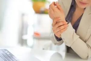woman rubbing her wrist with carpal tunnel pain