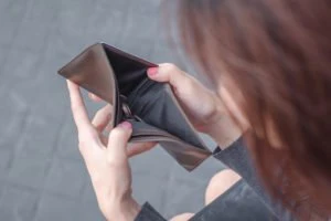 woman checking her empty wallet