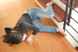 woman slipping and falling on a wood floor