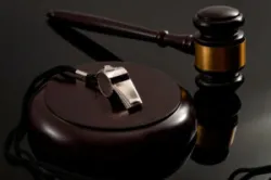 a gavel and a whistle on a whistleblower protection lawyer’s desk