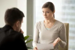 A woman asks an employment lawyer what to do after being unfairly terminated from her job.