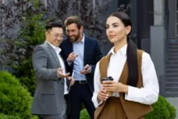 Woman holding a cup of coffee as two men harass her. She wonders if independent contractors can sue for harassment