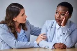 A sad woman whose work contract was unjustly terminated is consoled by a lawyer who tells her that she has time to file a claim within Rhode Island’s statute of limitations for wrongful termination.