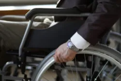 Businessman in wheelchair works with Boston disability discrimination lawyer on how to prove disability discrimination.