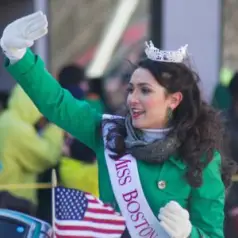 Miss Boston waving from a float in a St. Patrick’s Day parade