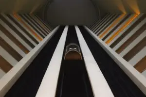upwards view of an elevator moving to the top floor