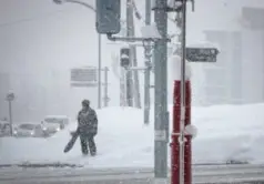 pedestrian standing outside in snowstorm