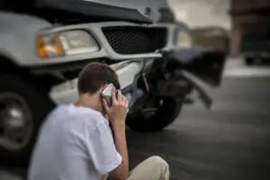 driver calling insurance company about car crash