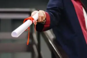 professor handing over a diploma at graduation