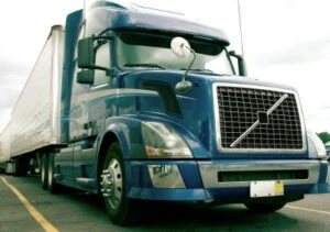 front view of parked blue semi-truck with trailer