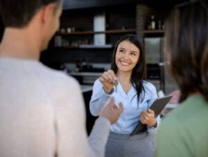 Landlord giving the keys to a happy couple.