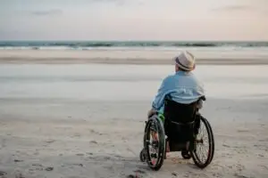 man in wheelchair at the beach