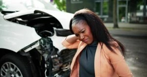 black woman with whiplash after a crash