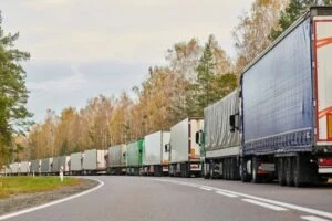 A line of Amazon trucks on the highway. What happens if an Amazon truck hits you?