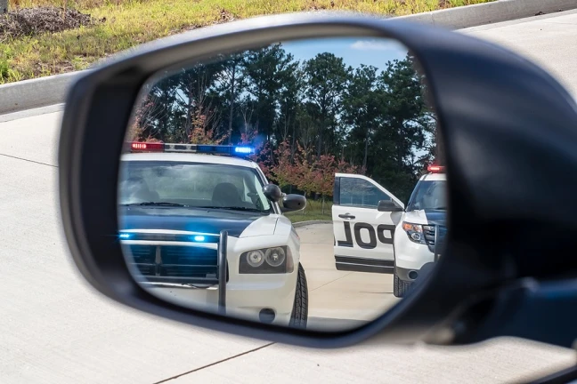 A police officer arresting a driver for DUI in San Jose