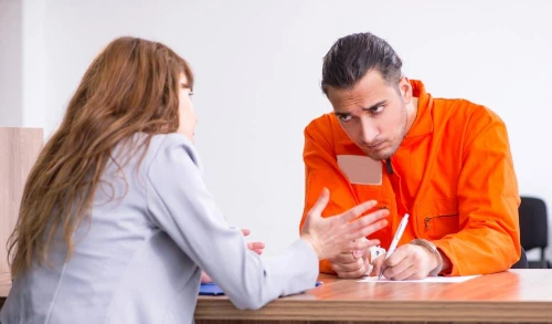 Lawyer explaining to a client who was arrested for domestic violence how long it will be before they can own a gun after their charge.