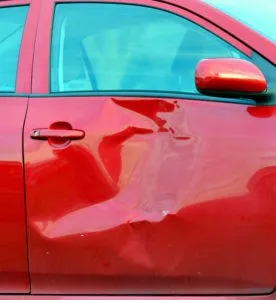 a red car with a smashed-in side door