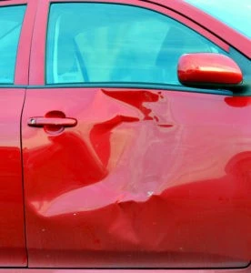 a red car with a smashed-in side door