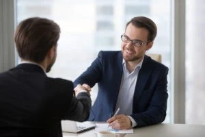 man shaking hands with his attorney