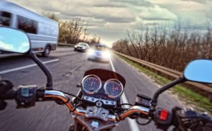 motorcycle about to get into a head-on collision with a car