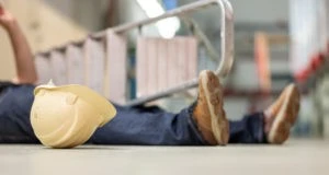 construction worker and helmet lying on the floor