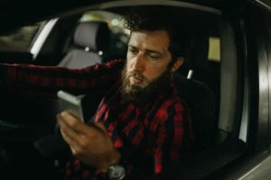 man texting while driving