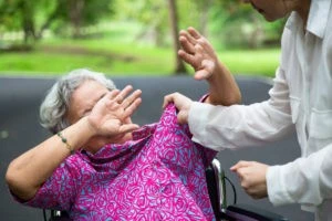 nurse about to hit an elderly patient