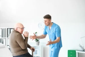 nurse abusing an elderly man