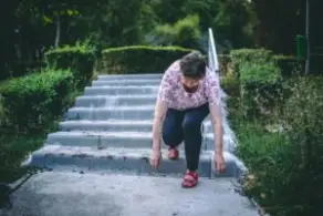 woman tripping and falling on stone steps