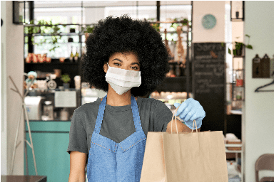 Woman with a mask handing over a bag