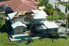 An aerial shot of a Florida house with roof damage caused by Hurricane Idalia.