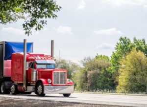 red big rig coming down the road