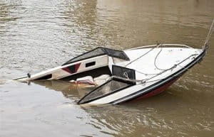 boat accident with sunken boat in brown lake water