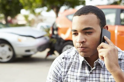 man calling police after a car accident