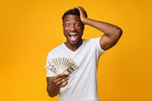 excited man holding a lot of money